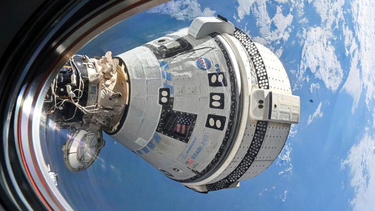 This photo provided by NASA shows Boeing's Starliner spacecraft which launched astronauts Butch Wilmore and Suni Williams to the International Space Station docked to the Harmony module's forward port on July 3, 2024, seen from a window on the SpaceX Dragon Endeavour spacecraft docked to the adjacent port. (NASA via AP) 